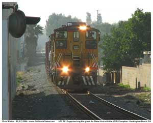 The LOA32 led by UPY 1212 climbs the grade as they approach Slater Ave with the empty cars from Reliable Lumber.