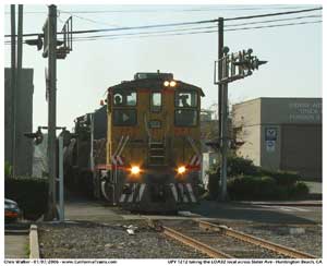 UPY 1212 crosses the grade at Slater Ave heading north back to the West Anaheim yard.