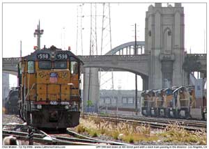 UPY 598 at the 4th Street yard as a wb stack train passes on the east bank of the LA river.