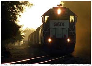 GMTX 2146 leads the LOA20 10 out of Los Nietos kicking up dust as they approach the grade crossing at Laurel Ave.