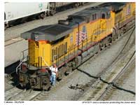 A conductor rides on the outside of UP 5771 as they reverse back towards the yard tracks.